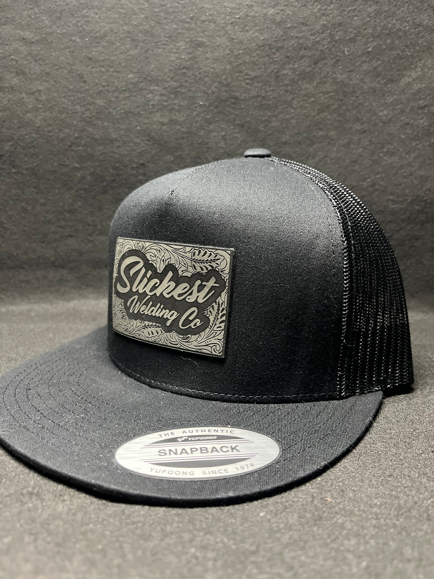 Black hat with dark grey patch