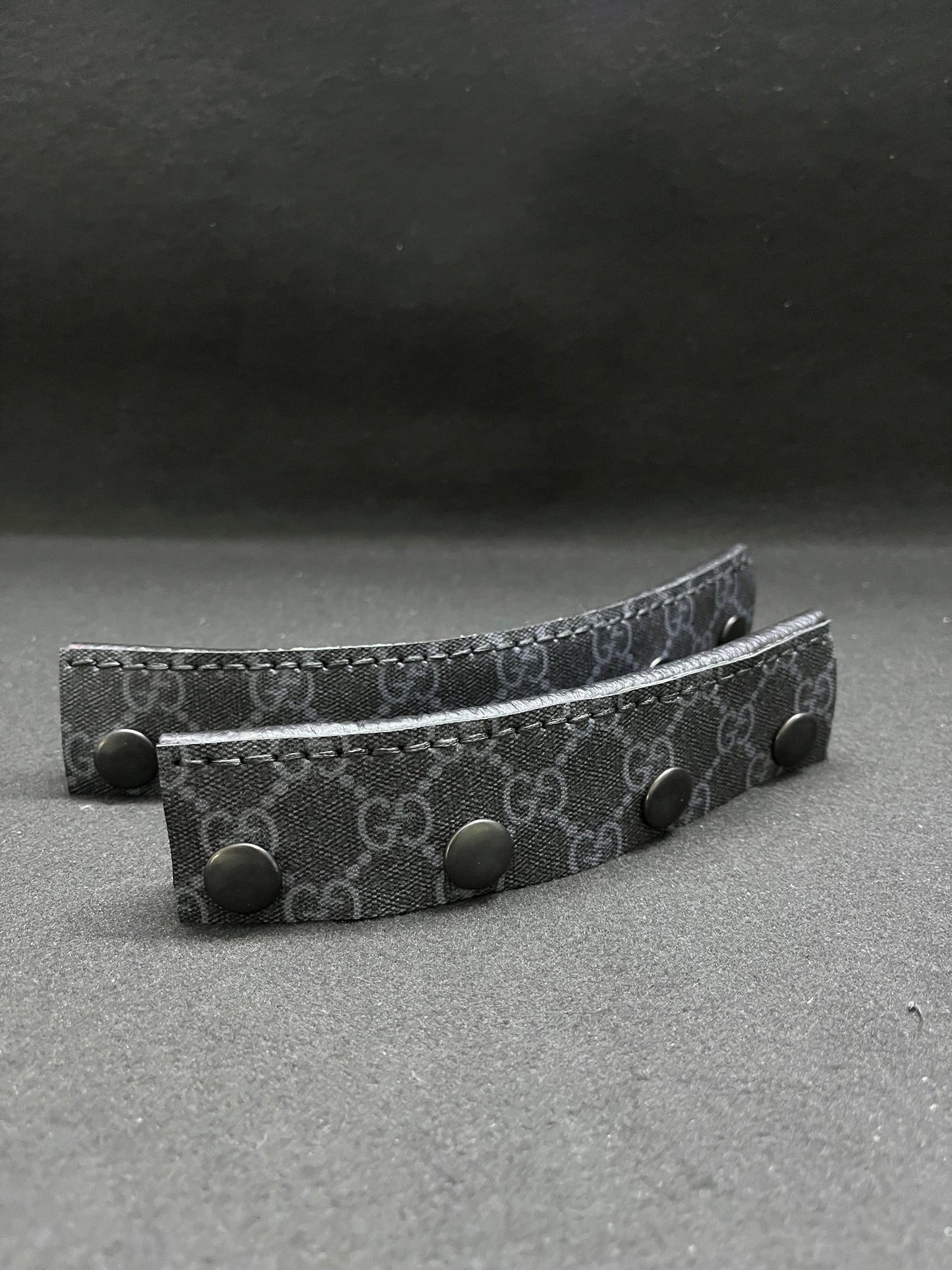 A set of black Gucci headbands