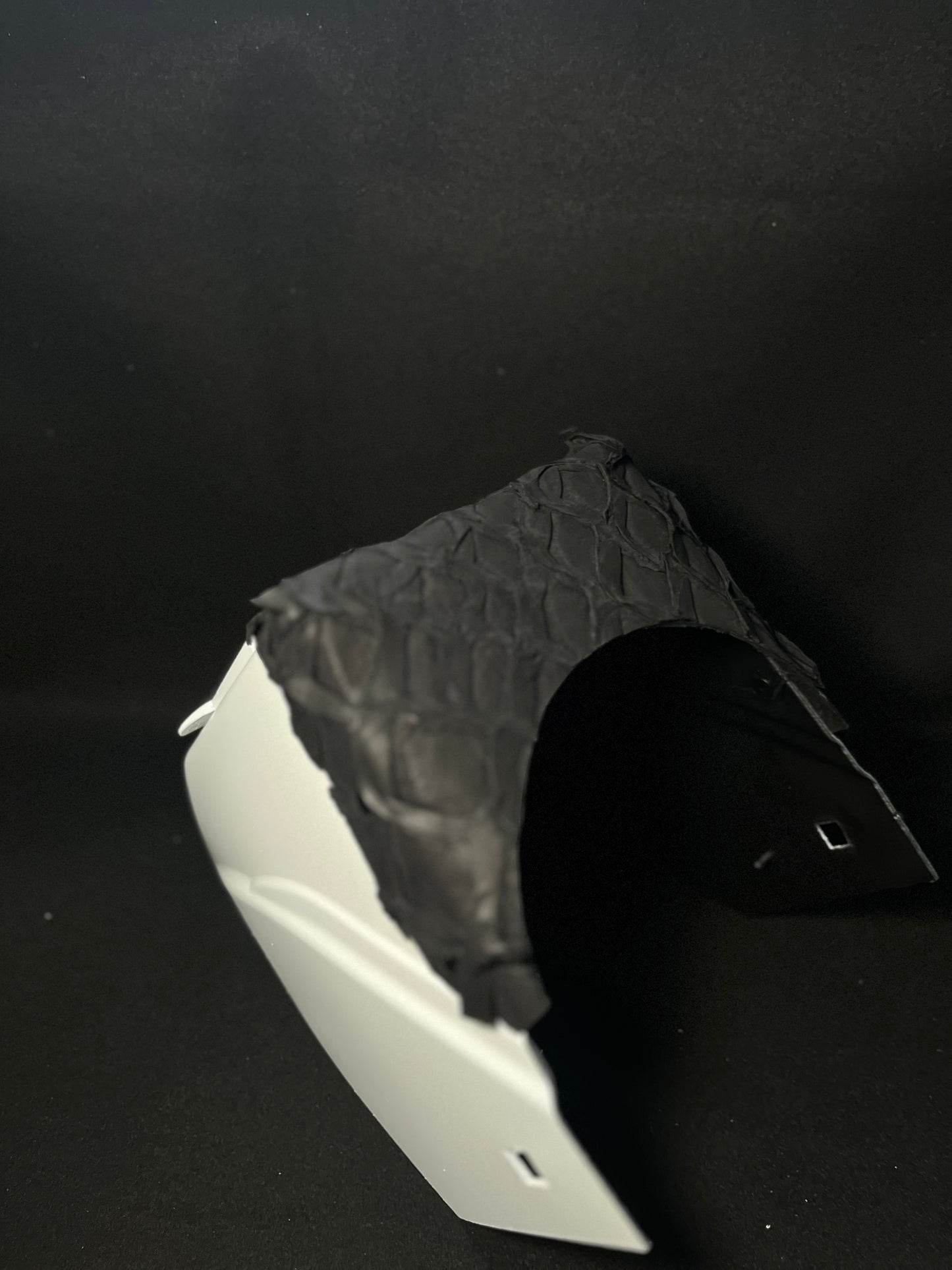 White hood with a matte black pirarucu top bib