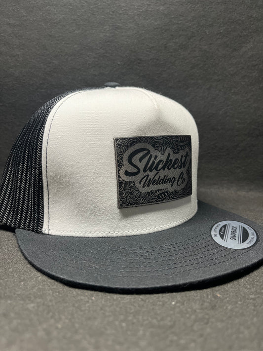Black and white hat with a silver patch