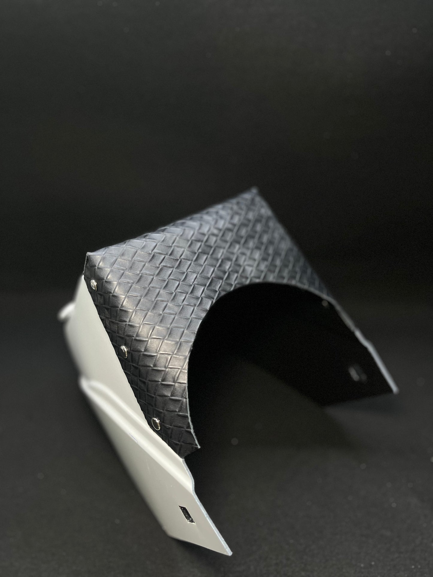 White hood with a black basketweave top bib