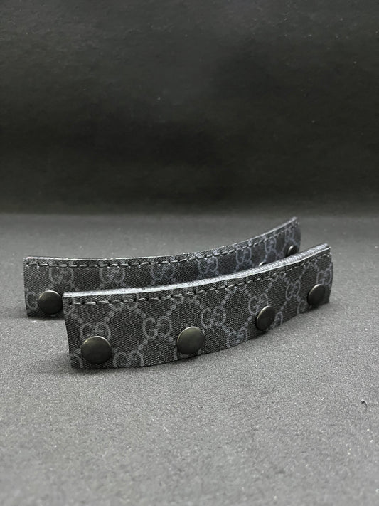 A set of black Gucci headbands